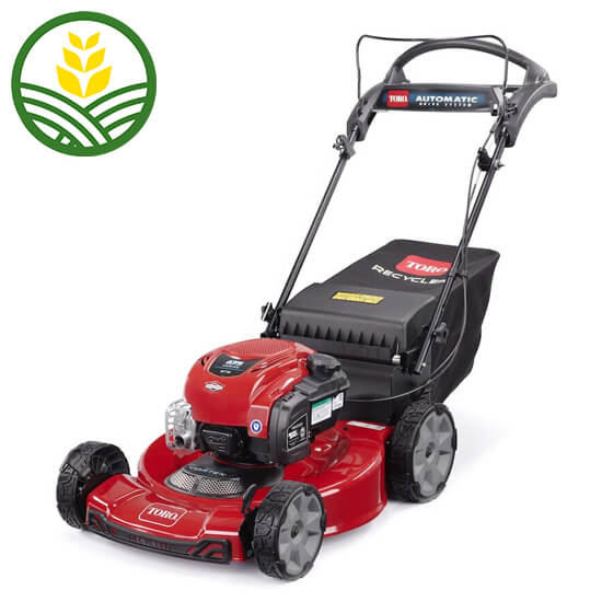 Toro push along mower with 4 wheels. Red body and black grass collector. Engine is positioned on top of the deck.