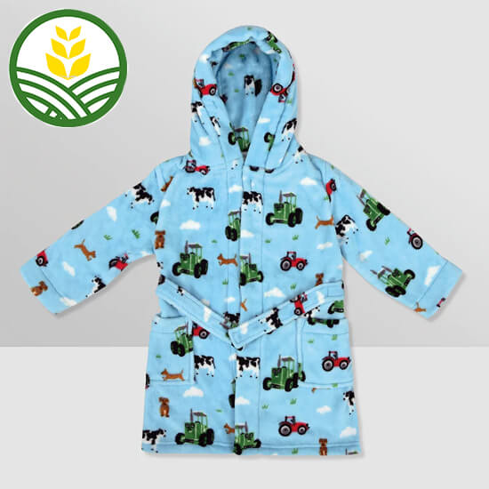 Light blue kids dressing gown with Tractor Ted pattern throughout.